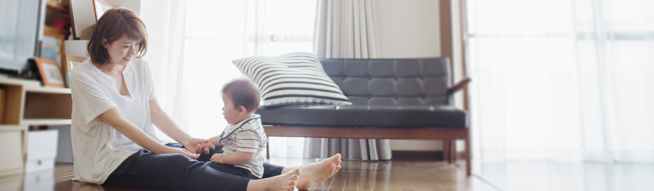 A young mom playing with her son in their home